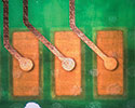 Figure 2. Examples of via and track patterns visible through the PCB. The interconnected solder pads on the top of the board are also visible.